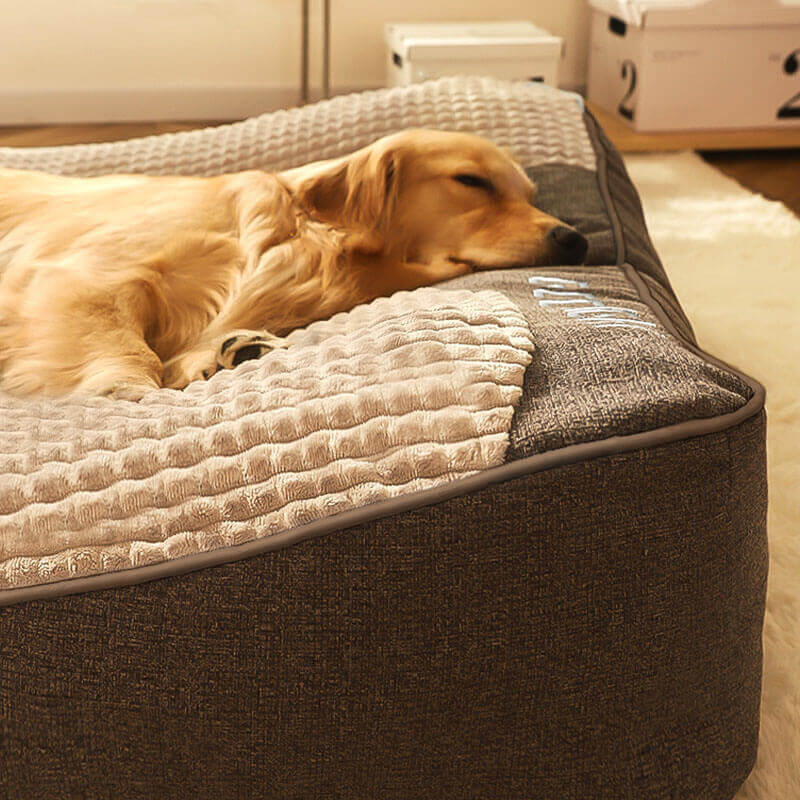 Comfortable large dog bed with a supportive memory foam mattress and integrated headrest for pet relaxation.
