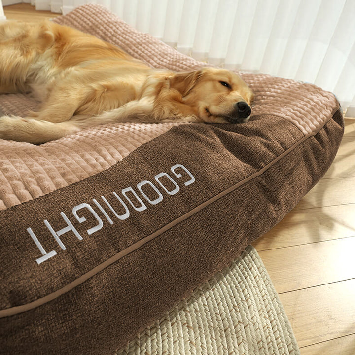 Washable large orthopedic dog bed with memory foam and a velvet headrest, ensuring pet comfort and hygiene.