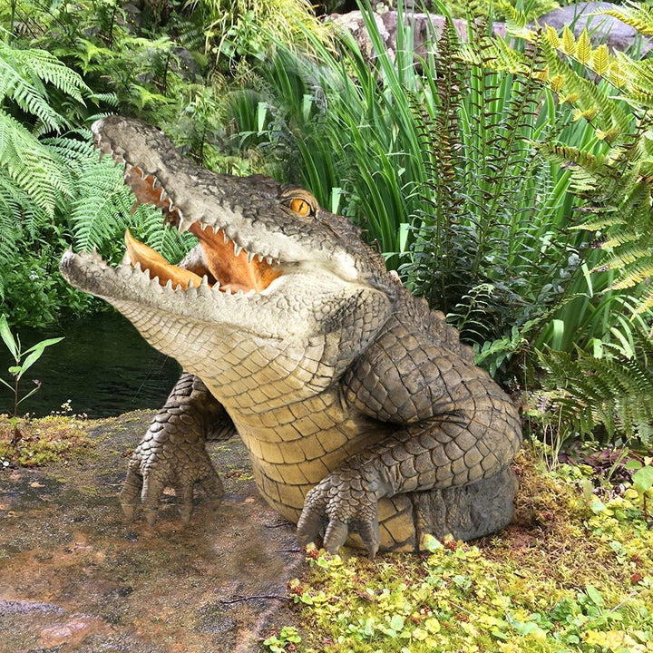 Lifelike alligator garden statue, realistic resin wildlife decor for outdoor lawn, pond, or patio.