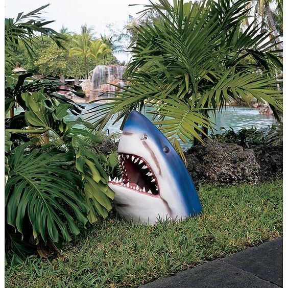 Dynamic view of resin shark outdoor statue, lifelike poolside decor for a unique garden accent.