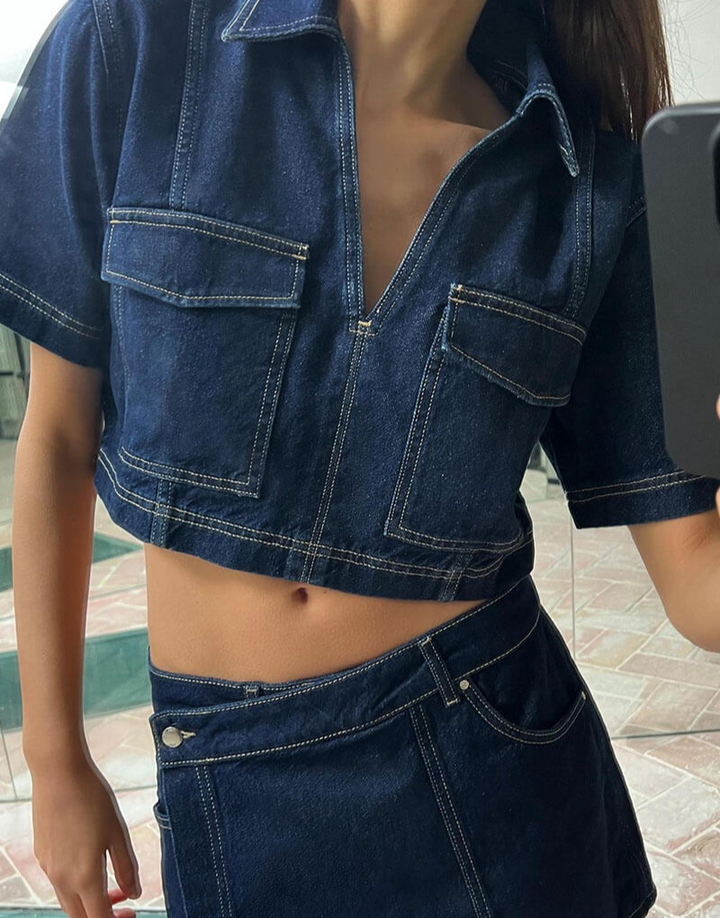 Casual women's denim two-piece set: stylish skort and crop top. Ideal for versatile summer fashion trends.