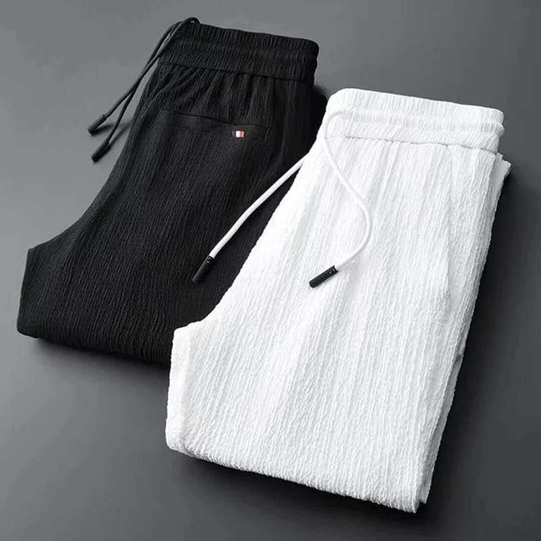 Man wearing a modern black lightweight summer two-piece set, perfect for stylish casual wear.