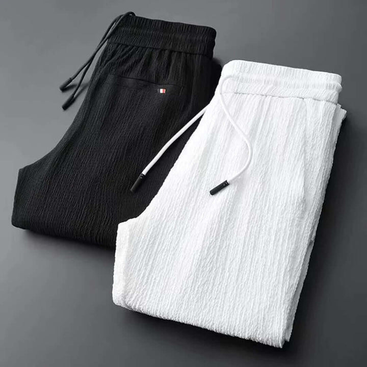 Man wearing a modern black lightweight summer two-piece set, perfect for stylish casual wear.