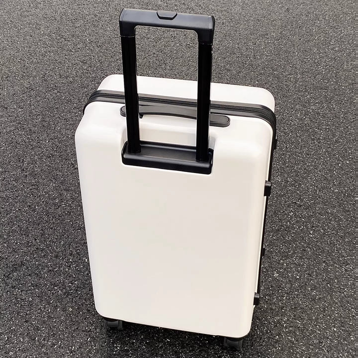 White hardshell travel suitcase, lightweight & impact-resistant, with smooth multi-directional spinner wheels.