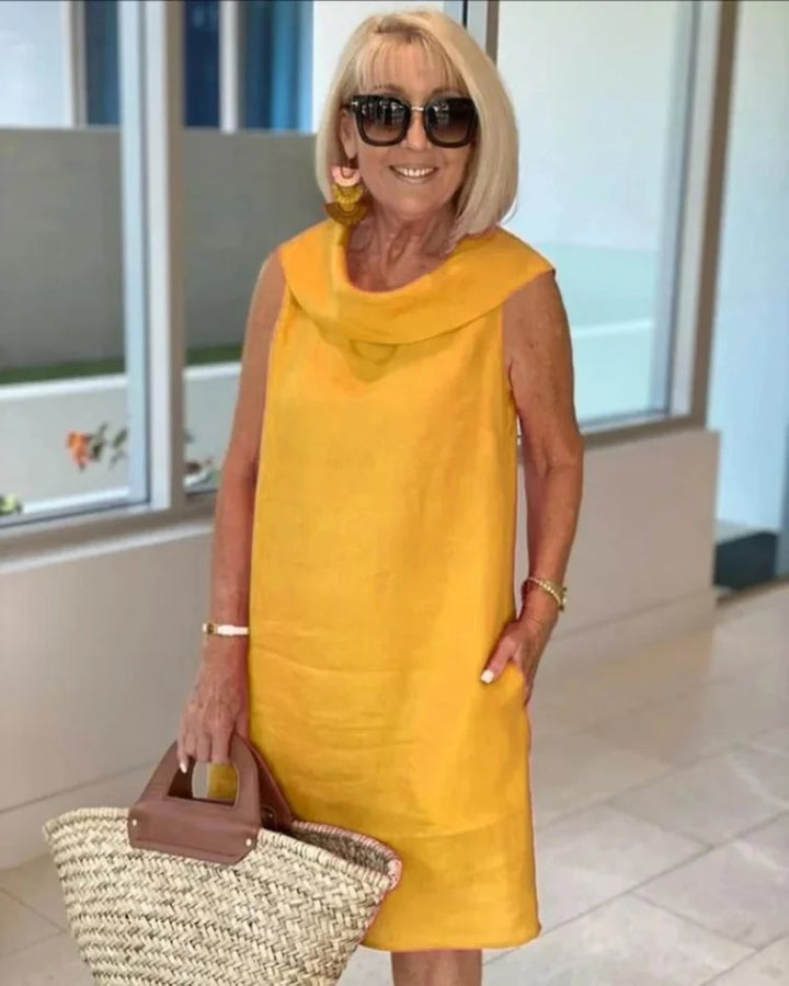 Vacation-ready women's flowy beach dress. Lightweight, sleeveless, and wide-neck for breezy summer style.