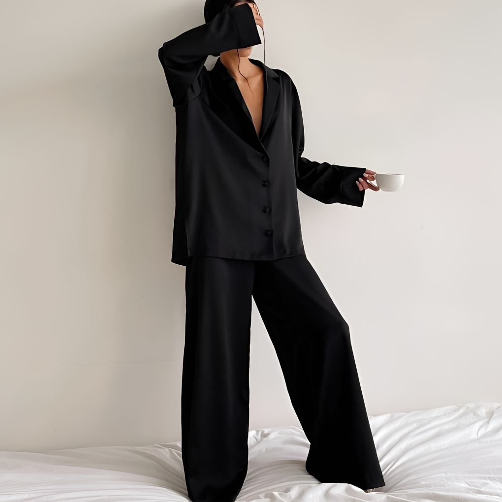 Luxurious black satin women's loungewear set. Comfortable two-piece pajamas with wide-leg pants for stylish sleepwear.