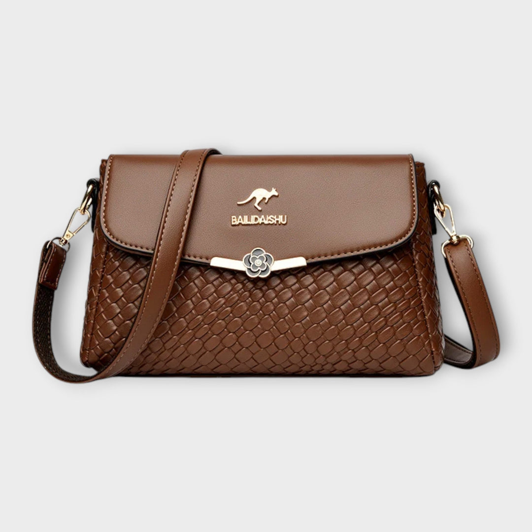 Stylish women's textured crossbody shoulder bag. Elegant faux leather purse, a chic day to night fashion accessory.