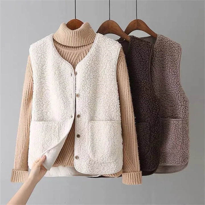 Stylish women's button-up fleece gilet, a warm and elegant layering vest for cool weather fashion.