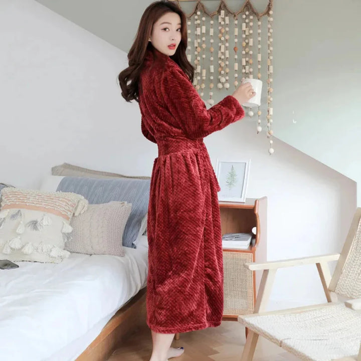 Ultra-soft women's plush bathrobe with hood, crafted from polyester fleece for luxurious, comfortable loungewear.