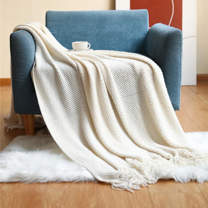 Plush merino-style home decor blanket, soft and comfortable acrylic throw with elegant tassels.