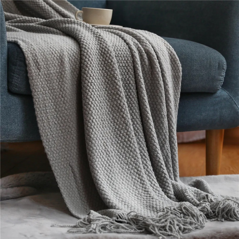 Soft merino-style living room throw blanket, cozy acrylic with elegant tassels for modern home decor.