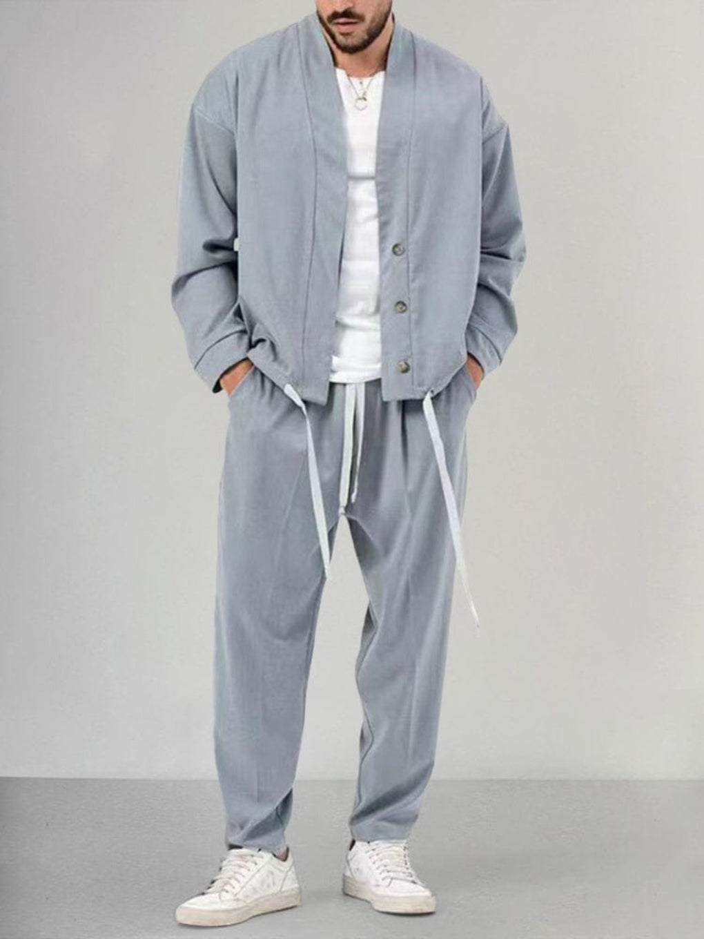 Man relaxing at home in a cozy men's 2-piece relaxed fit lounge set, ideal for comfort and relaxed casual wear.