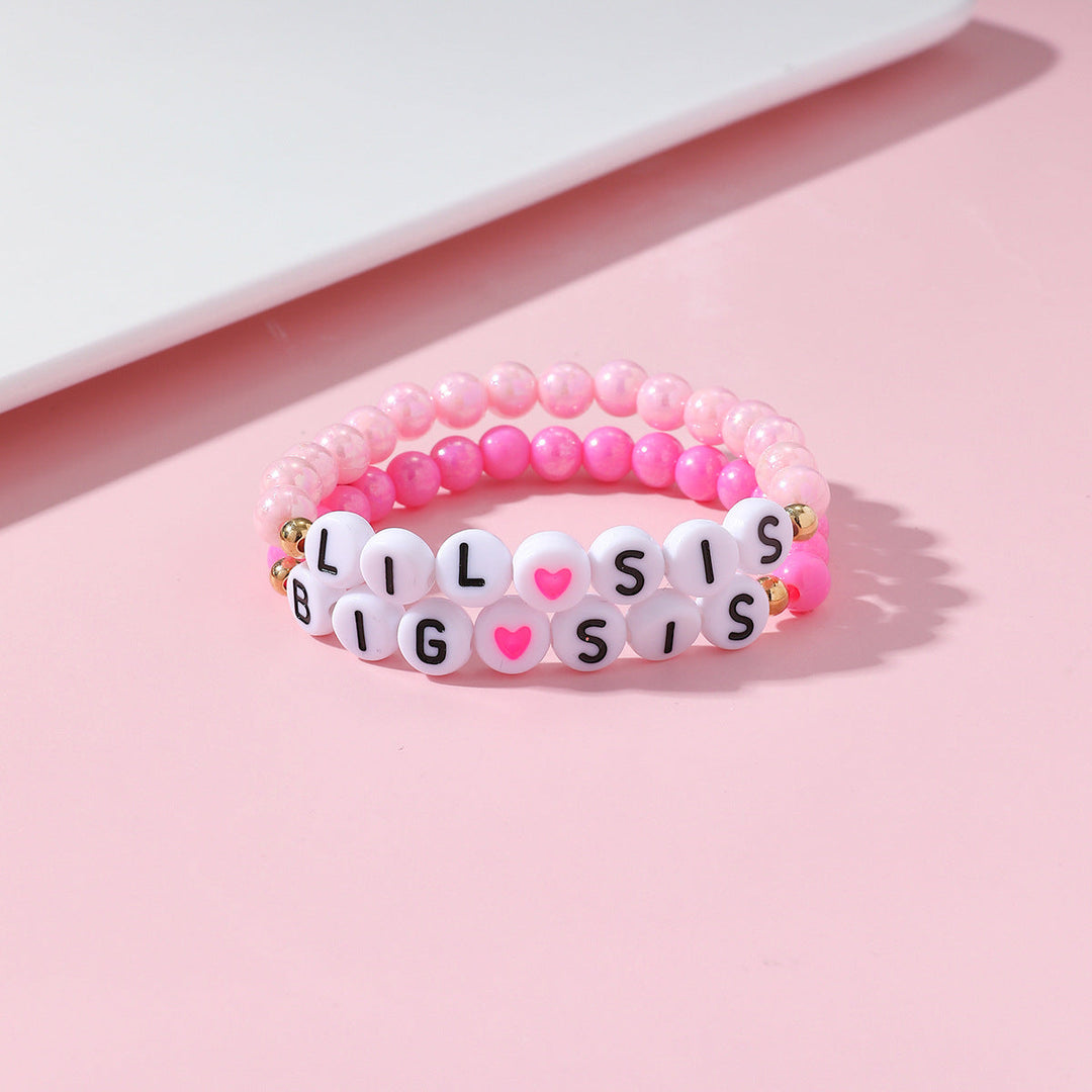 Elastic sister bracelet set with colorful beads & heart charms. Adjustable, ideal gift for siblings or best friends.