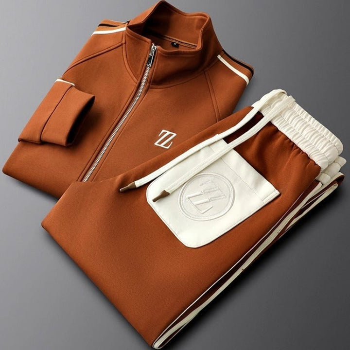 Coordinated men's athletic tracksuit with zip jacket and tapered pants, showcasing modern stripe detail.