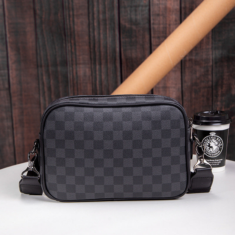 Versatile men's black checked leather messenger bag with multiple compartments. Ideal crossbody for work & travel.