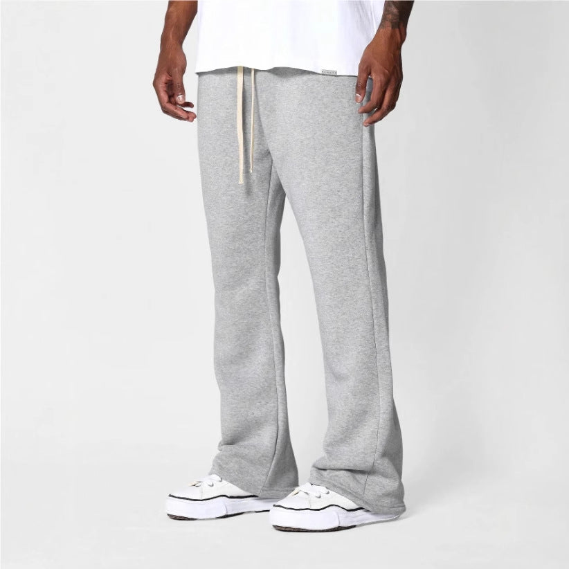 Men's black flared sweatpants with relaxed fit, drawstring waist, perfect for comfortable loungewear & casual style.