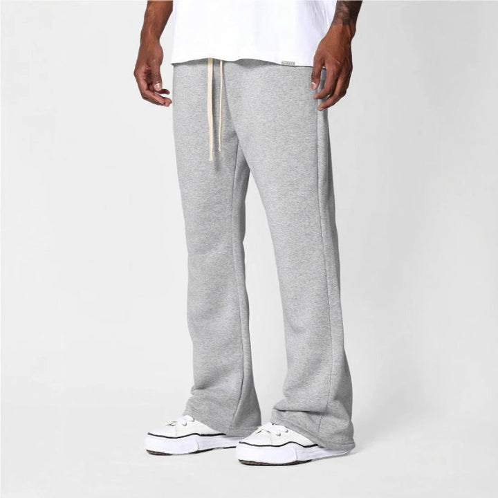 Men's black flared sweatpants with relaxed fit, drawstring waist, perfect for comfortable loungewear & casual style.
