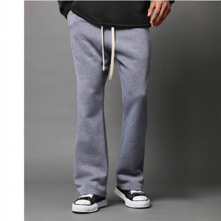 Stylish men's light grey flared sweatpants, relaxed fit, ideal for effortless casual wear & ultimate comfort.