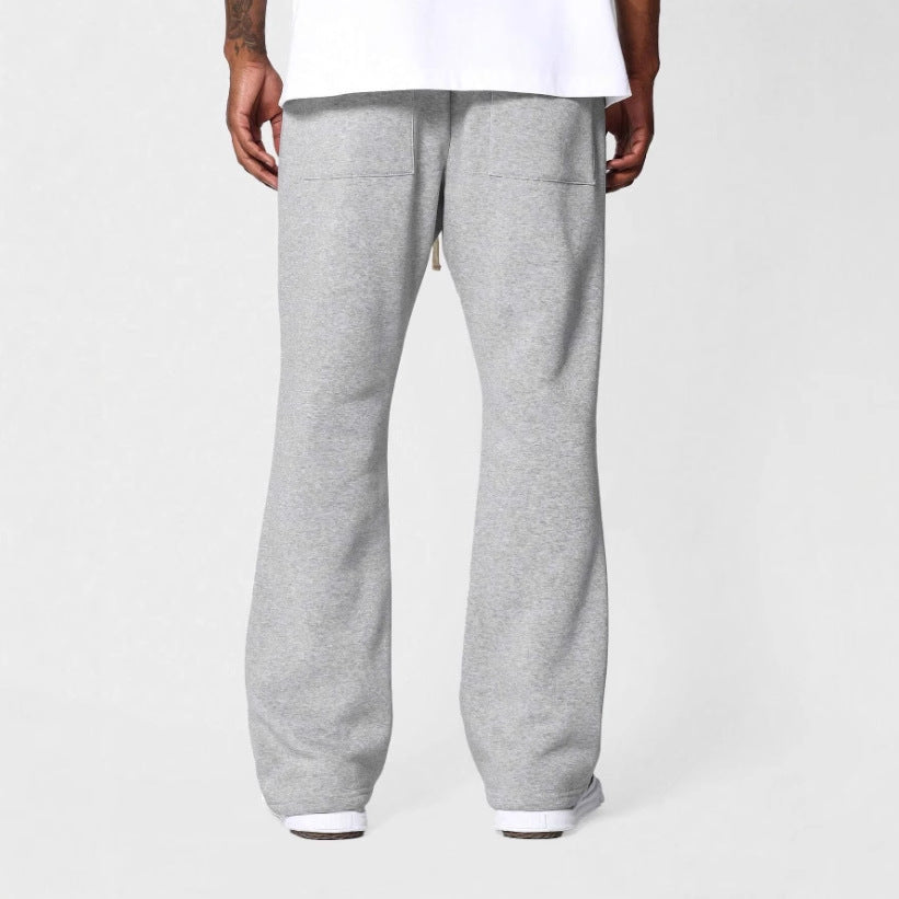 Modern men's flared sweatpants with drawstring waist, relaxed fit, providing comfortable & stylish casual wear.