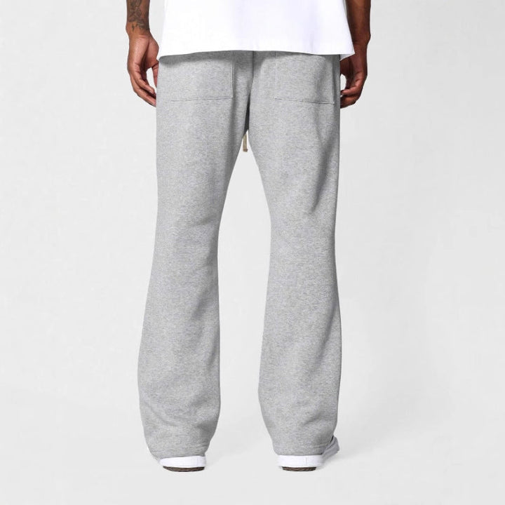 Modern men's flared sweatpants with drawstring waist, relaxed fit, providing comfortable & stylish casual wear.