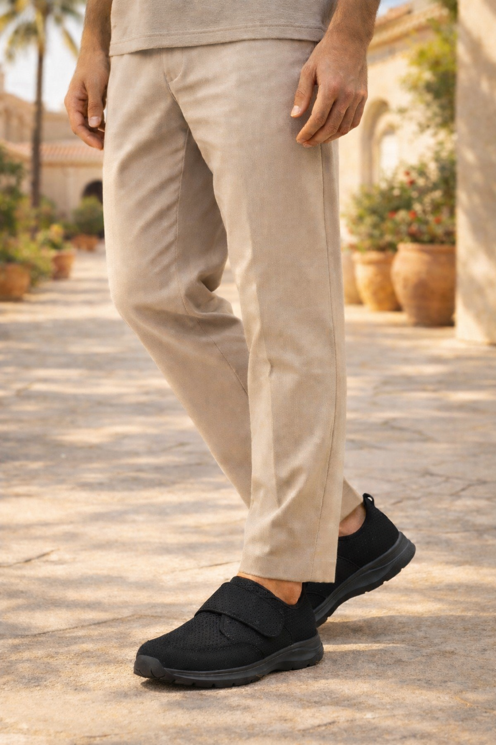 Men's black orthopedic slip-on walking sneakers with adjustable strap for ultimate comfort and support. Easy wear.