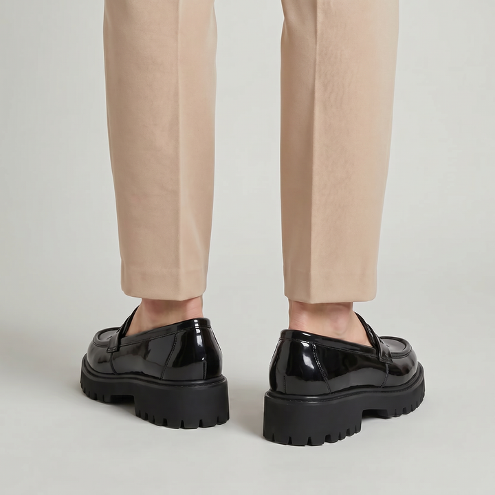Detailed men's platform penny loafers, featuring a comfortable slip-on design and modern dress shoe aesthetic.