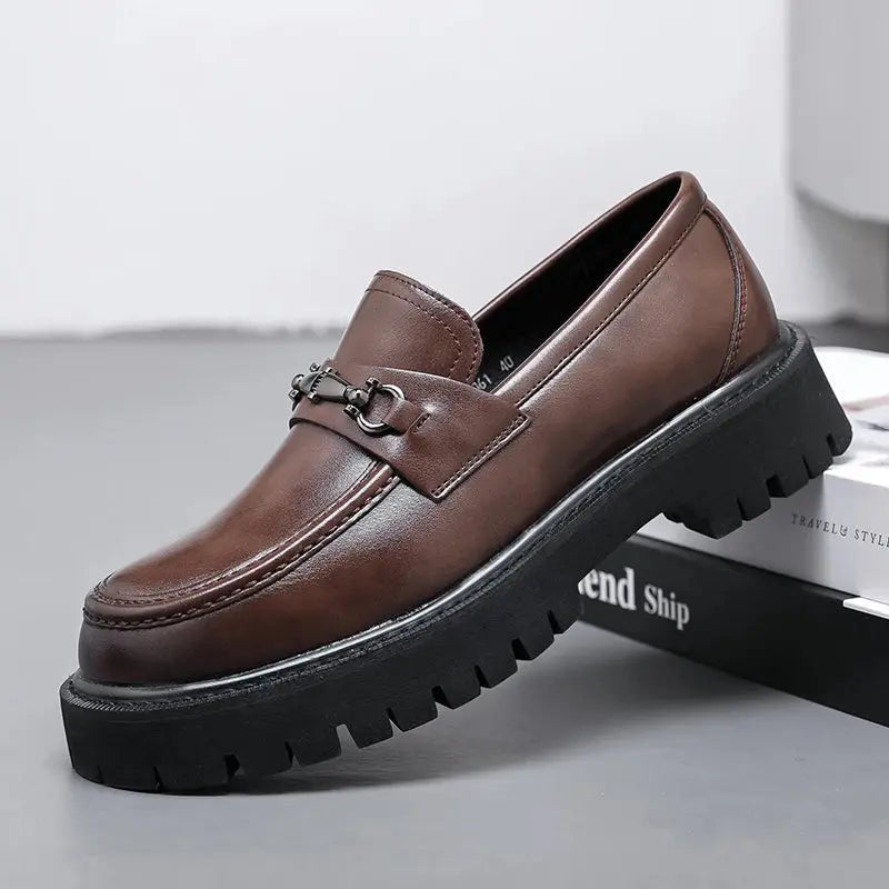 Men's black slip-on loafers with elegant metal buckle, perfect for smart casual or business attire.