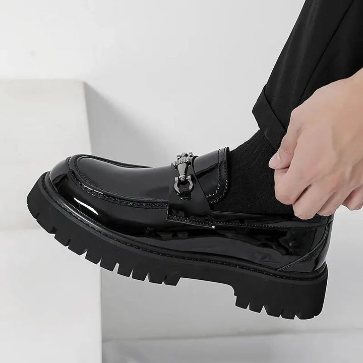 Comfortable and stylish men's slip-on loafers with a distinctive metal buckle, for a refined smart look.