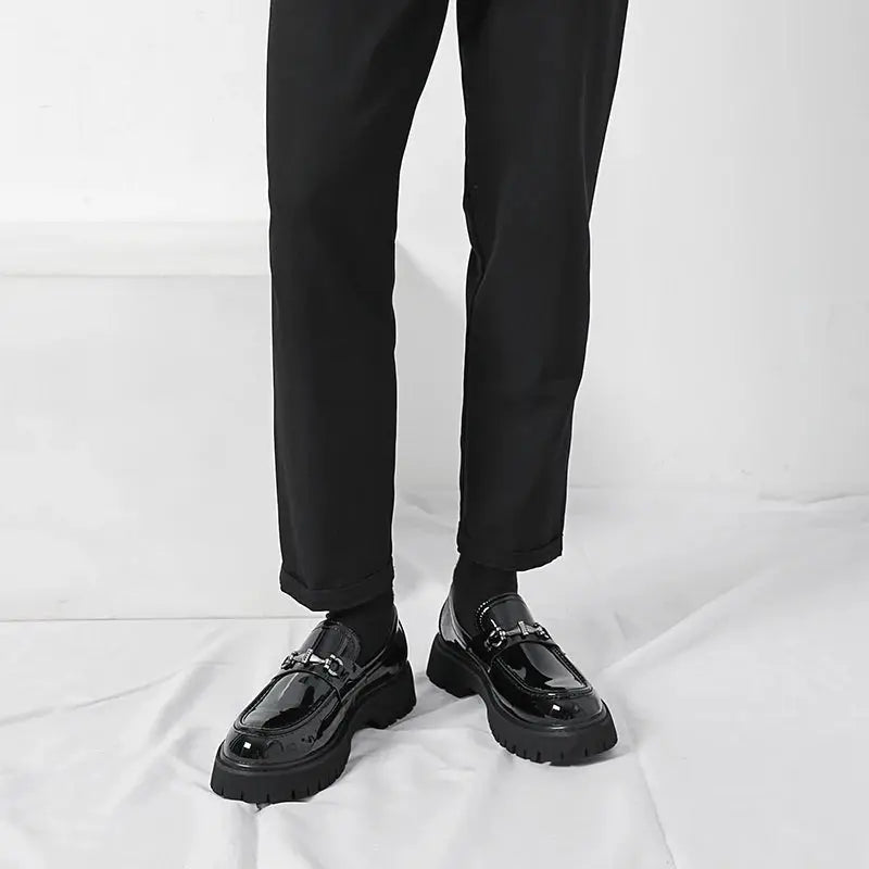Slip-on mens business shoes, black, with a prominent metal buckle, designed for elegance & comfort.