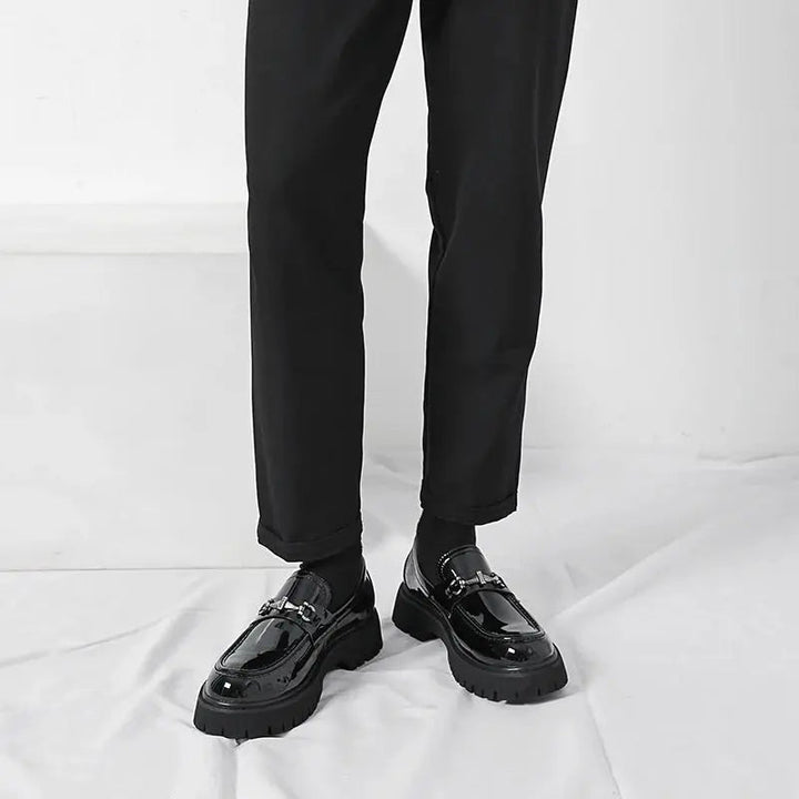 Slip-on mens business shoes, black, with a prominent metal buckle, designed for elegance & comfort.