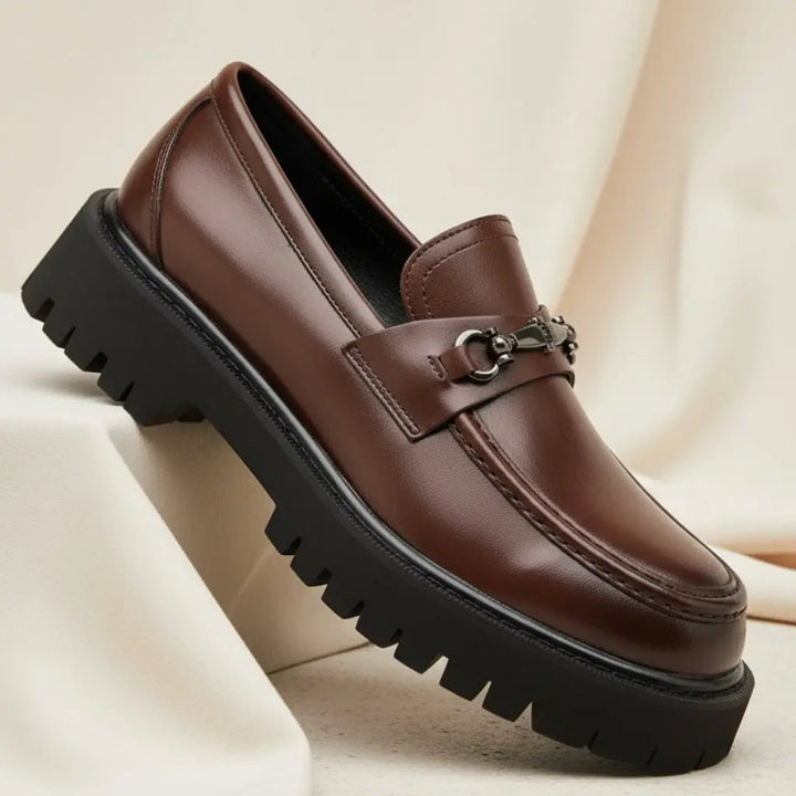 Stylish brown slip-on loafers for men, featuring a sleek metal buckle, ideal for a refined gentleman.