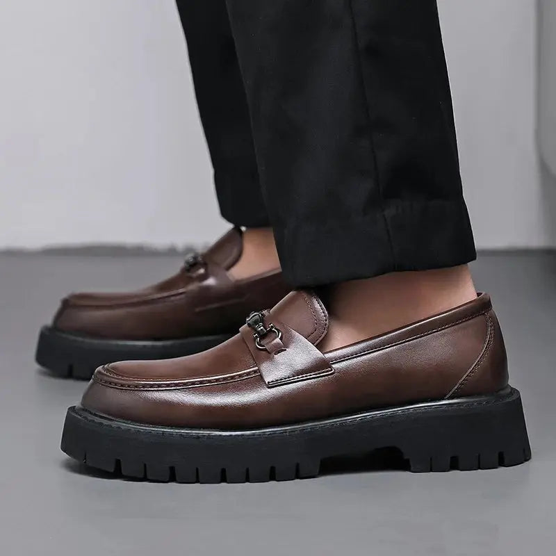 Fashionable brown slip-on mens shoes, detailed with a chic metal buckle, for a sophisticated look.