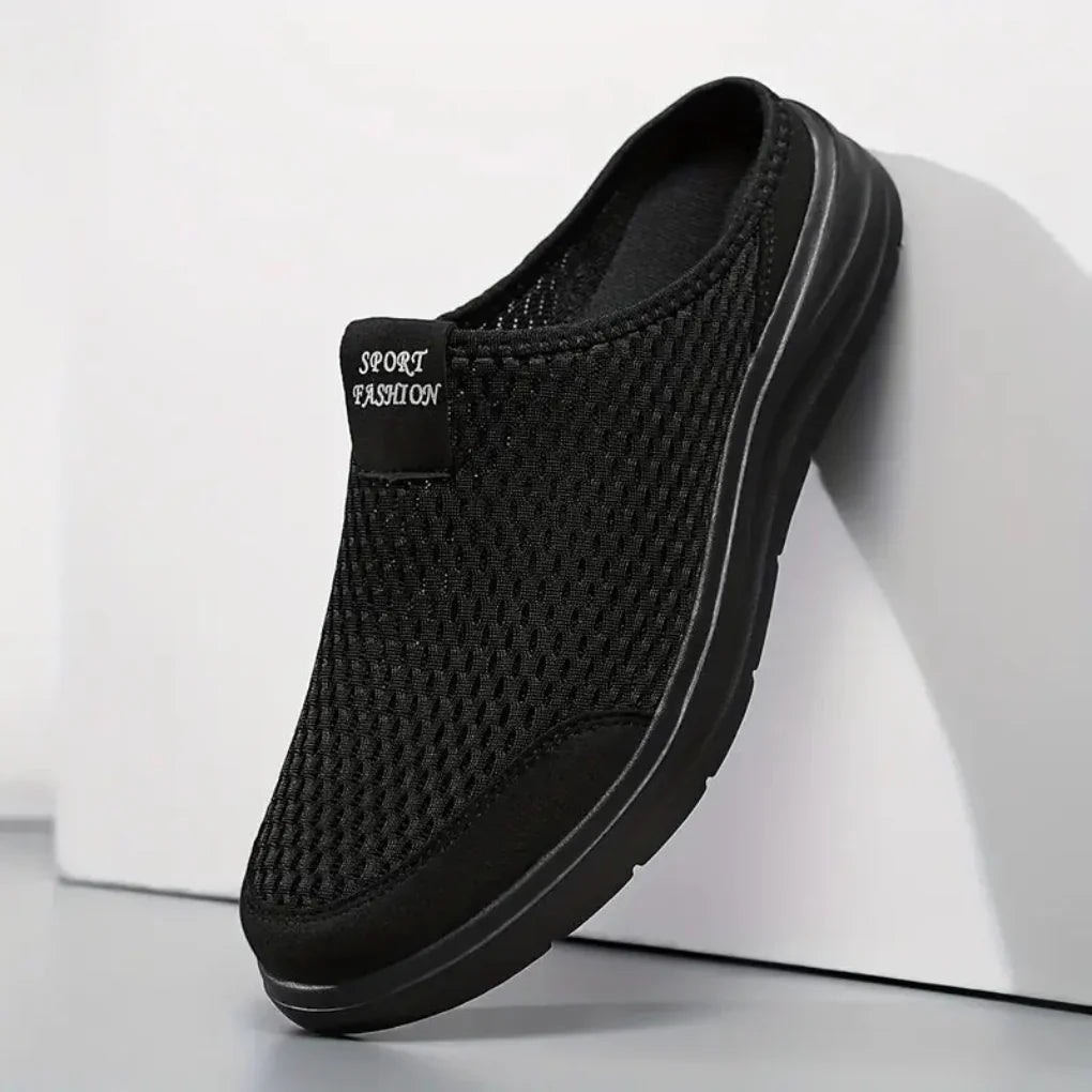 Men's black slip-on sandals with arch support for all-day comfort, perfect for summer casual wear and outdoor travel.