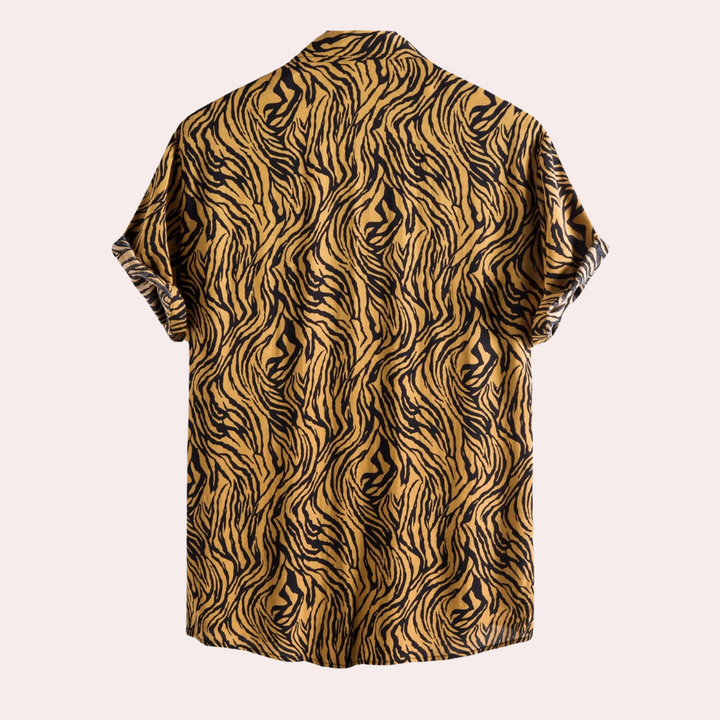 Close-up of a men's vibrant animal print short sleeve shirt, showcasing a bold tiger pattern and casual style.
