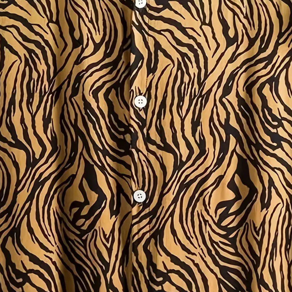 Man in a trendy yellow tiger print short sleeve shirt, featuring a relaxed fit. Ideal for summer casual fashion.