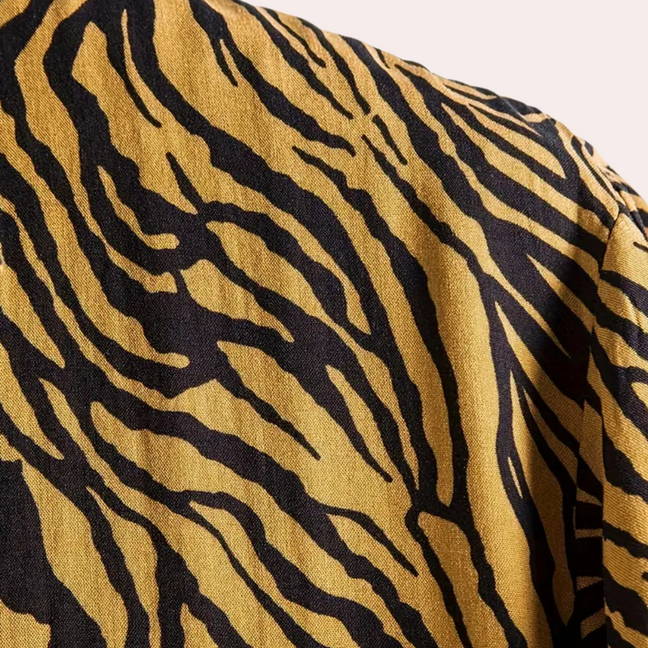 Detailed view of a men's statement short sleeve shirt, highlighting the bold tiger print and relaxed summer fit.