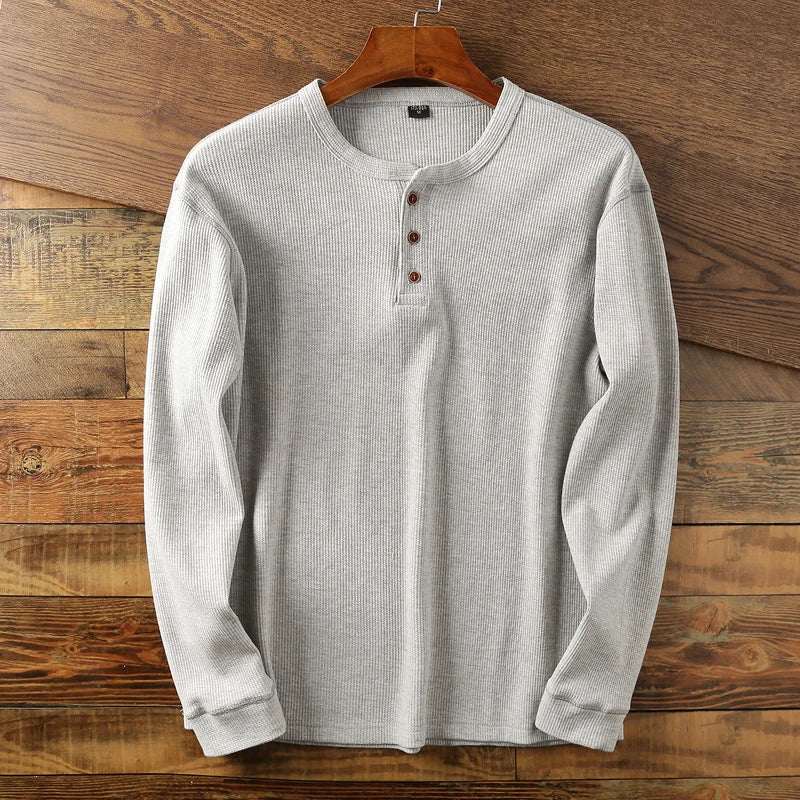 Comfortable men's long sleeve waffle henley in navy, a versatile casual top.