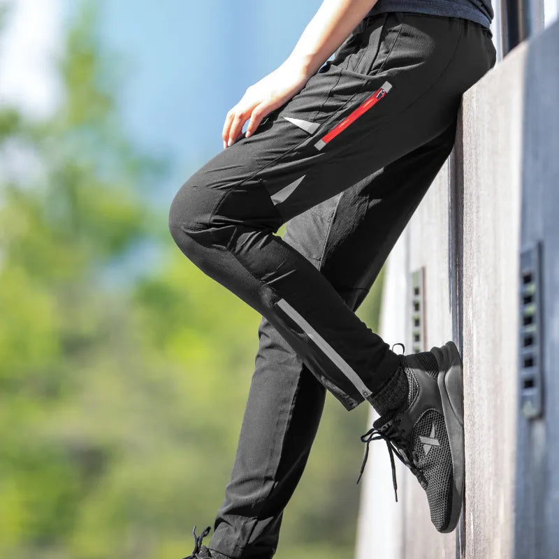 Tapered fit men's cycling trousers featuring stretch fabric, breathability, and reflective elements for activewear.