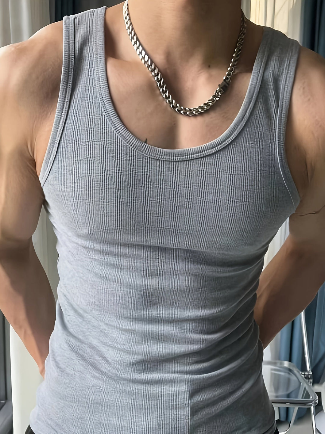 Athletic man wearing a lightweight, breathable tank top during an intense summer workout. Comfortable fit.