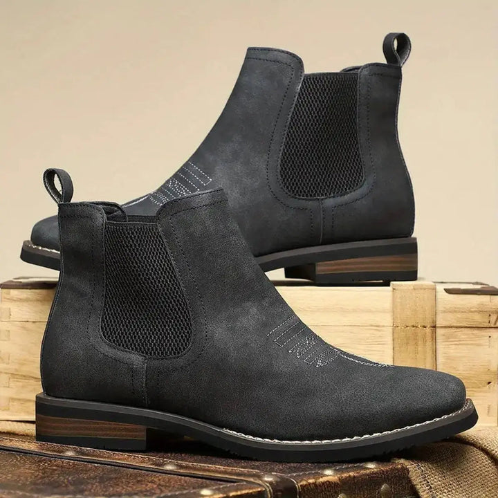 Detailed view of the unique western stitch on men's brown leather Chelsea ankle boots. Block heel visible.