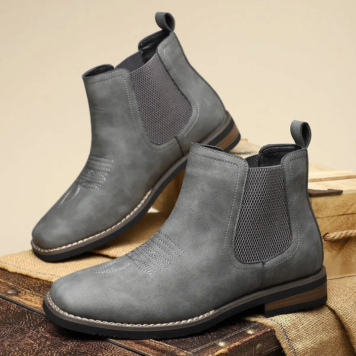 Modern men's grey Chelsea boots, smart casual pull-on ankle boots with distinctive western stitch detail.