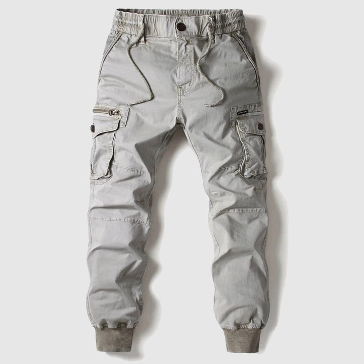 Khaki men's cargo joggers, utility pants with multi-pockets & elastic waist, casual streetwear style.