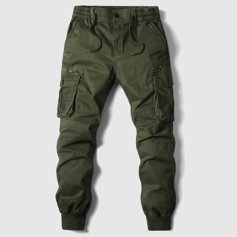 Green men's cargo joggers. Durable utility pants with multiple pockets, perfect for outdoor & casual style.