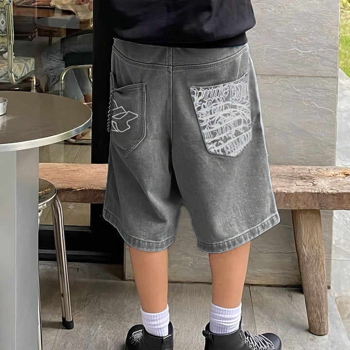 Stylish men's fashion: Bermuda shorts with unique floral embroidery design, loose-fit denim.