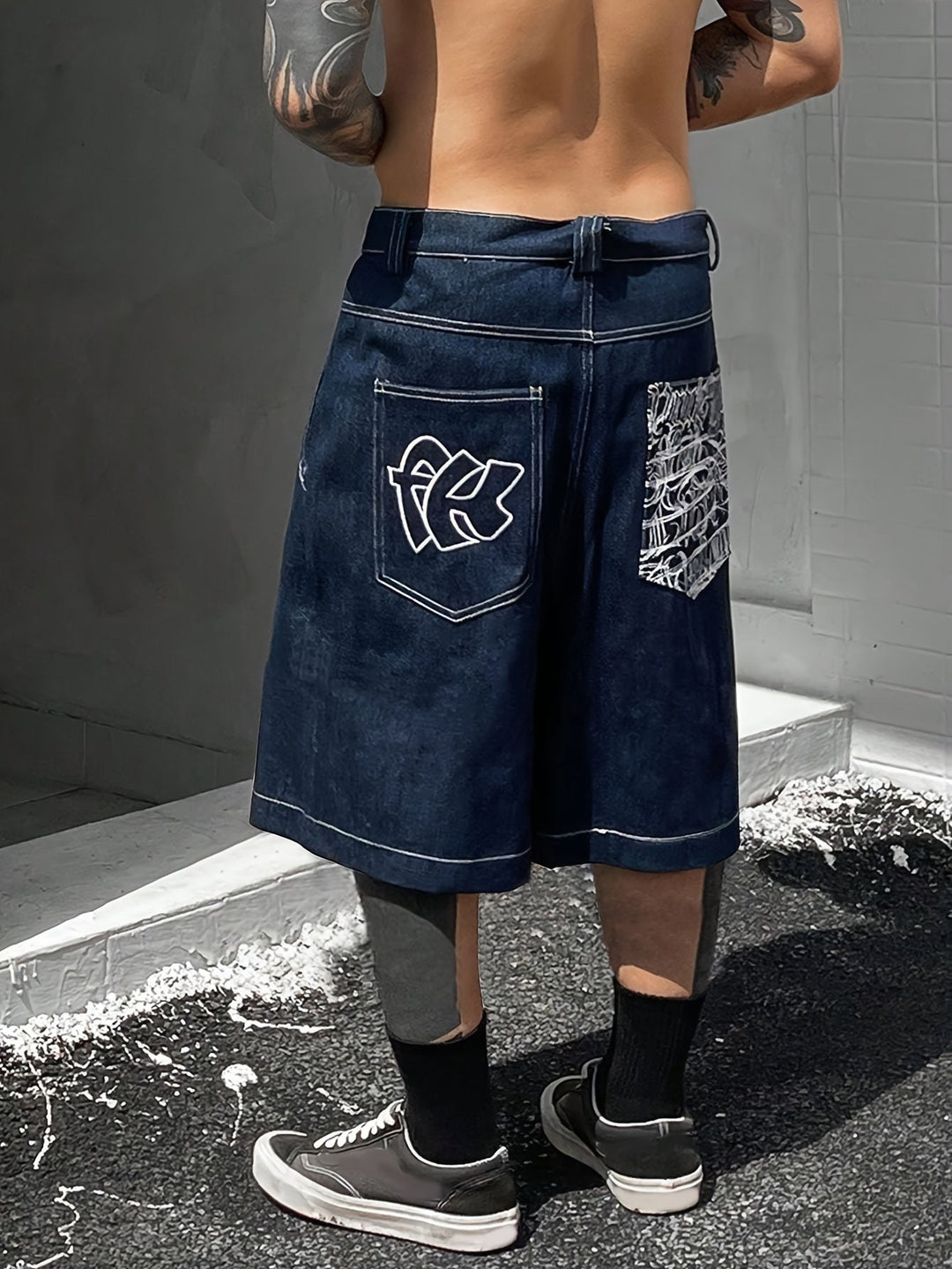 Front view: Men's casual Bermuda denim shorts with eye-catching floral embroidery & loose fit.