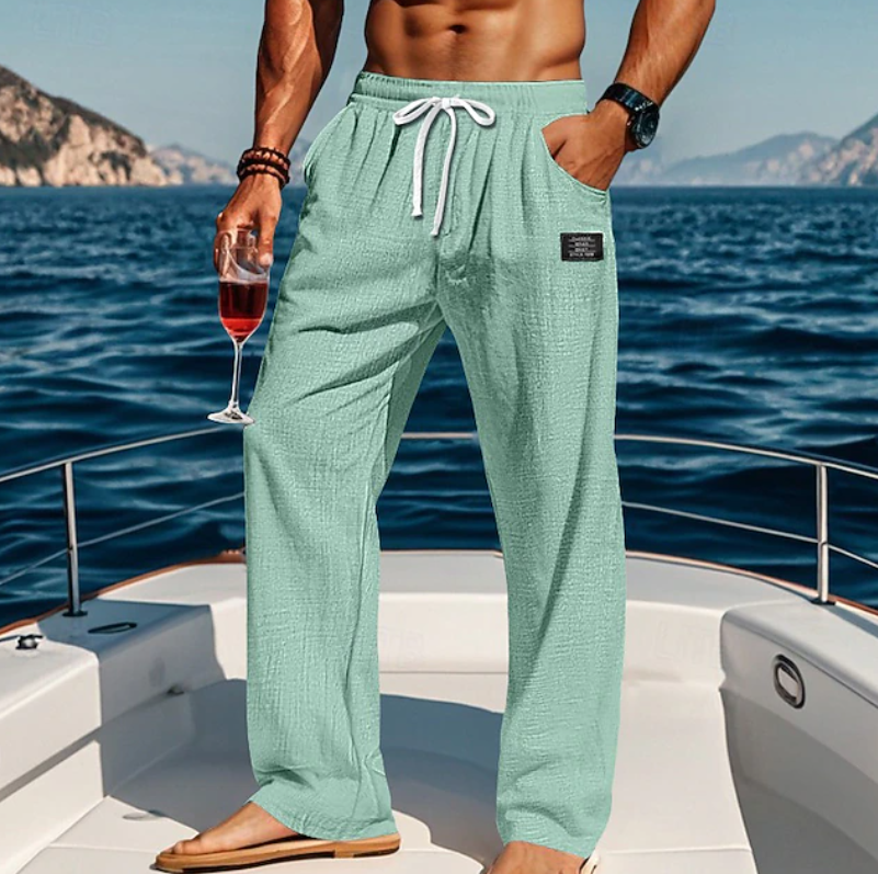 Man wearing loose, breathable casual summer trousers with lace waist. Ideal for beach, vacation, or relaxed daily wear.
