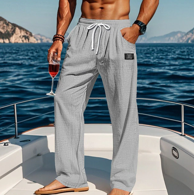 Stylish men's summer loose trousers. Breathable, lightweight fabric, relaxed fit, and lace-up waist for casual comfort.