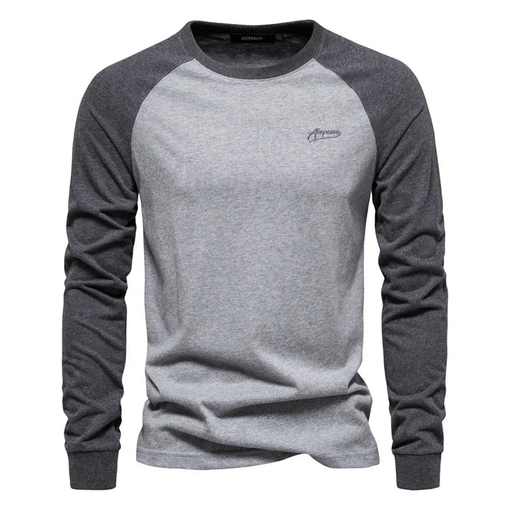 Modern men's raglan long sleeve top, featuring a crew neck for casual comfort & versatile layering.