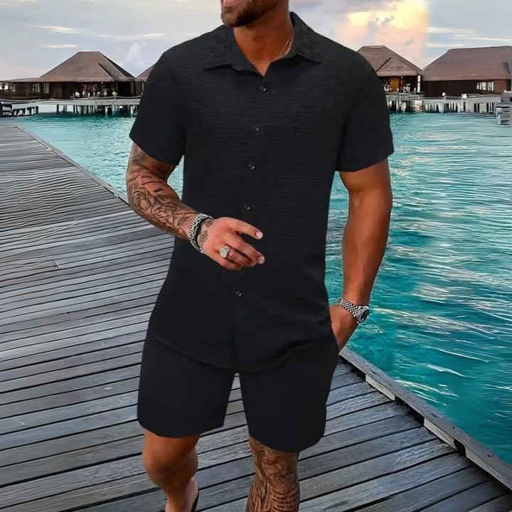 Stylish men's two-piece casual set with short sleeve button-up shirt and comfortable shorts.