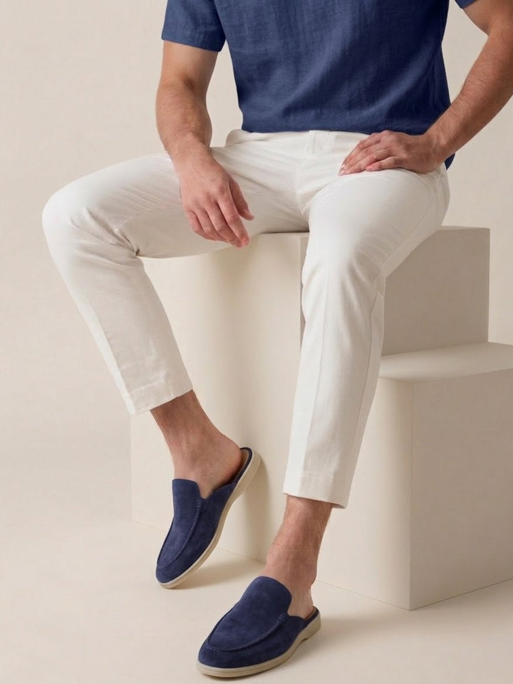Lifestyle shot: Men's casual slip-on mules with open heel & stitched detail. Relaxed, easy wear fashion.